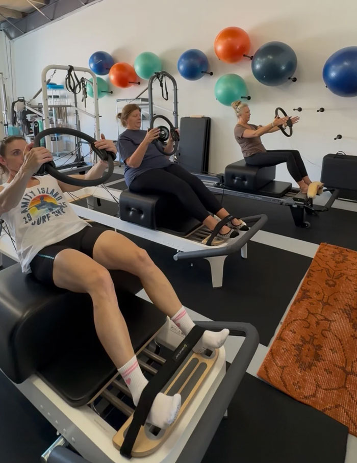 A group mat Pilates class working with props