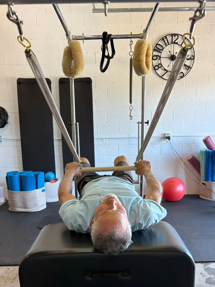Kelly Gorder, founder of Wabi-Sabi Pilates, working with a client on the Cadillac