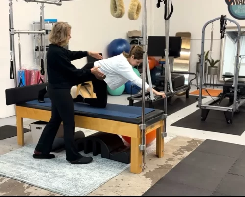 Two clients in a duo Pilates session with an instructor